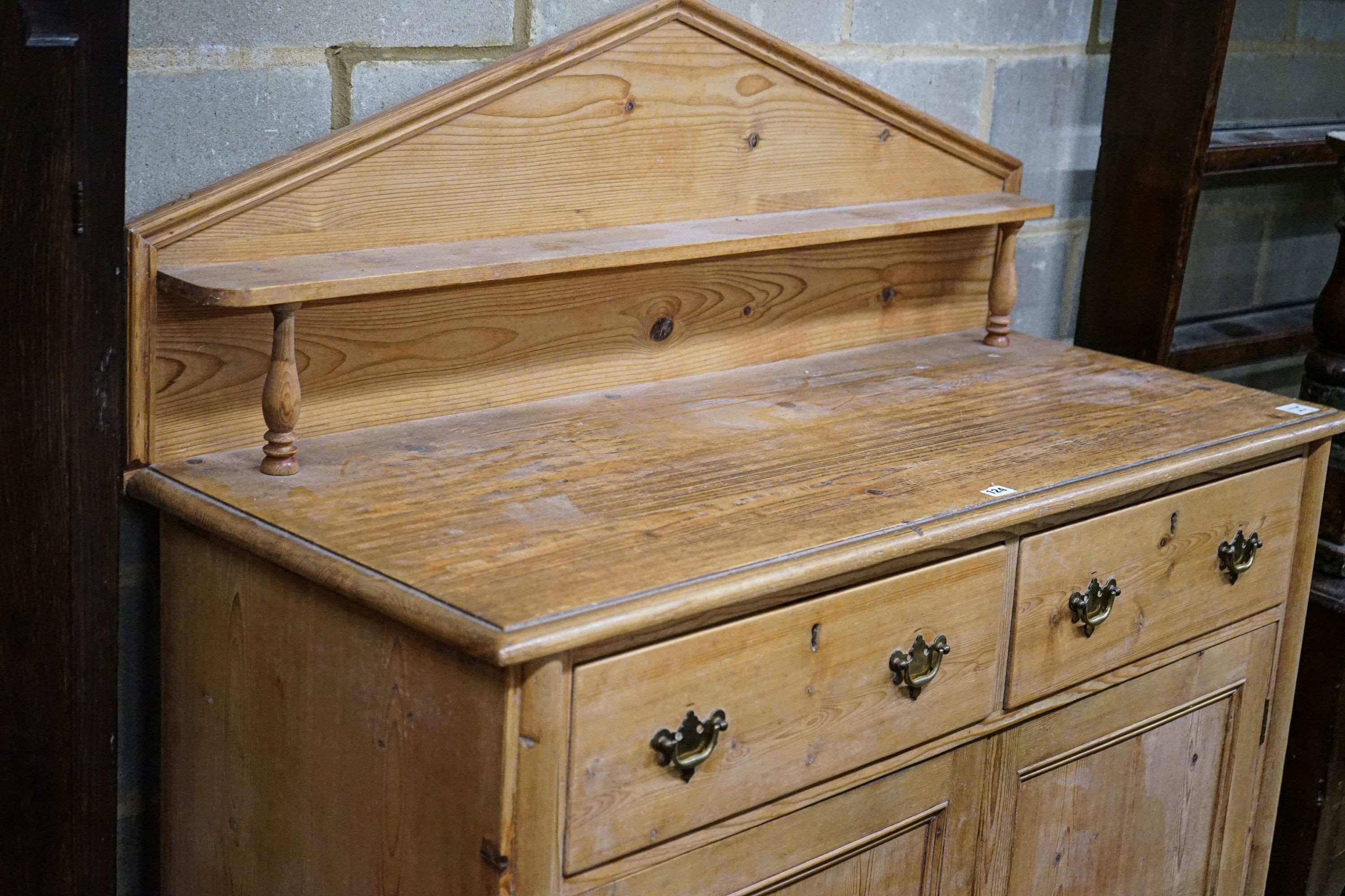 An early Victorian pine chiffonier, fitted two drawers and panelled doors on turned feet, width 121cm, depth 50cm, height 142cm